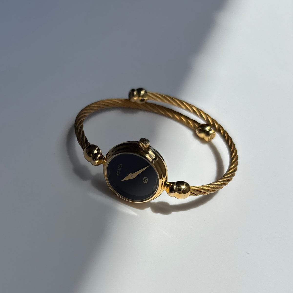 Gucci 1990s Black Round Dial Cable Gold Plated Bangle Watch