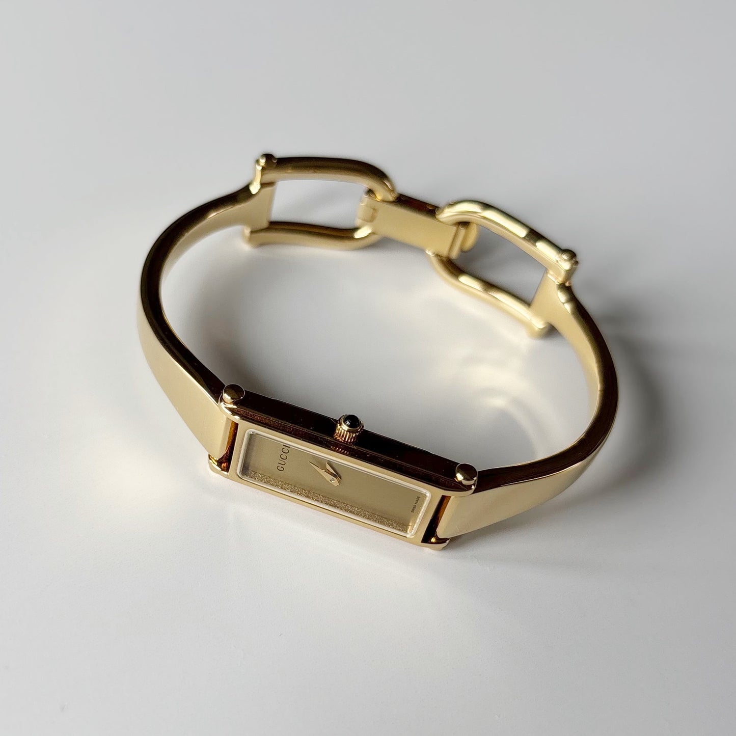Gucci 1990s Gold Rectangular Dial Gold Plated Bangle Watch