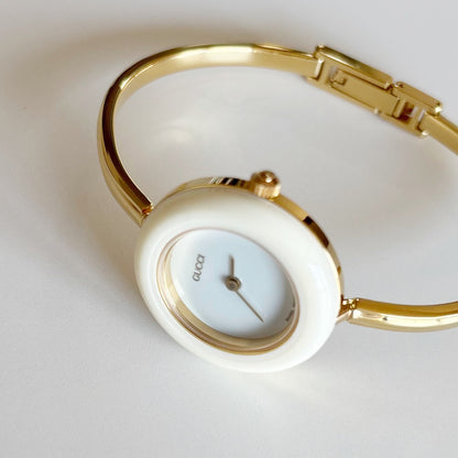 Gucci 1990s Interchangeable Bezel Gold Plated Bangle Watch with 12 bezels, case