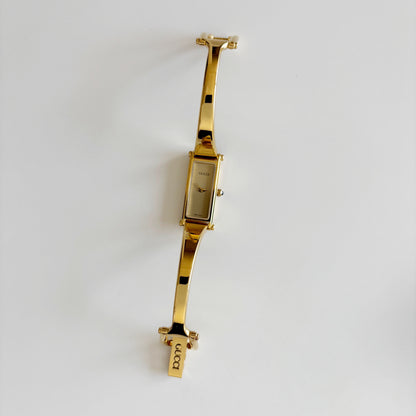 Gucci 1990s Rectangular Gold Dial Gold Plated Bangle Watch