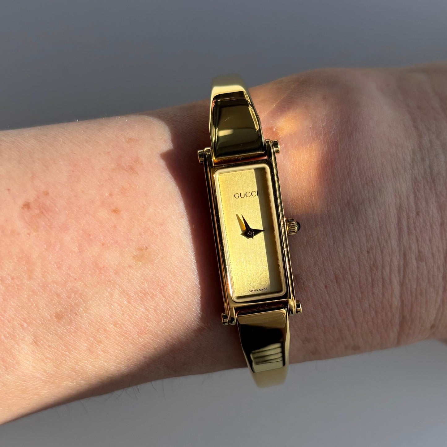 Gucci 1990s Rectangular Gold Dial Gold Plated Bangle Watch