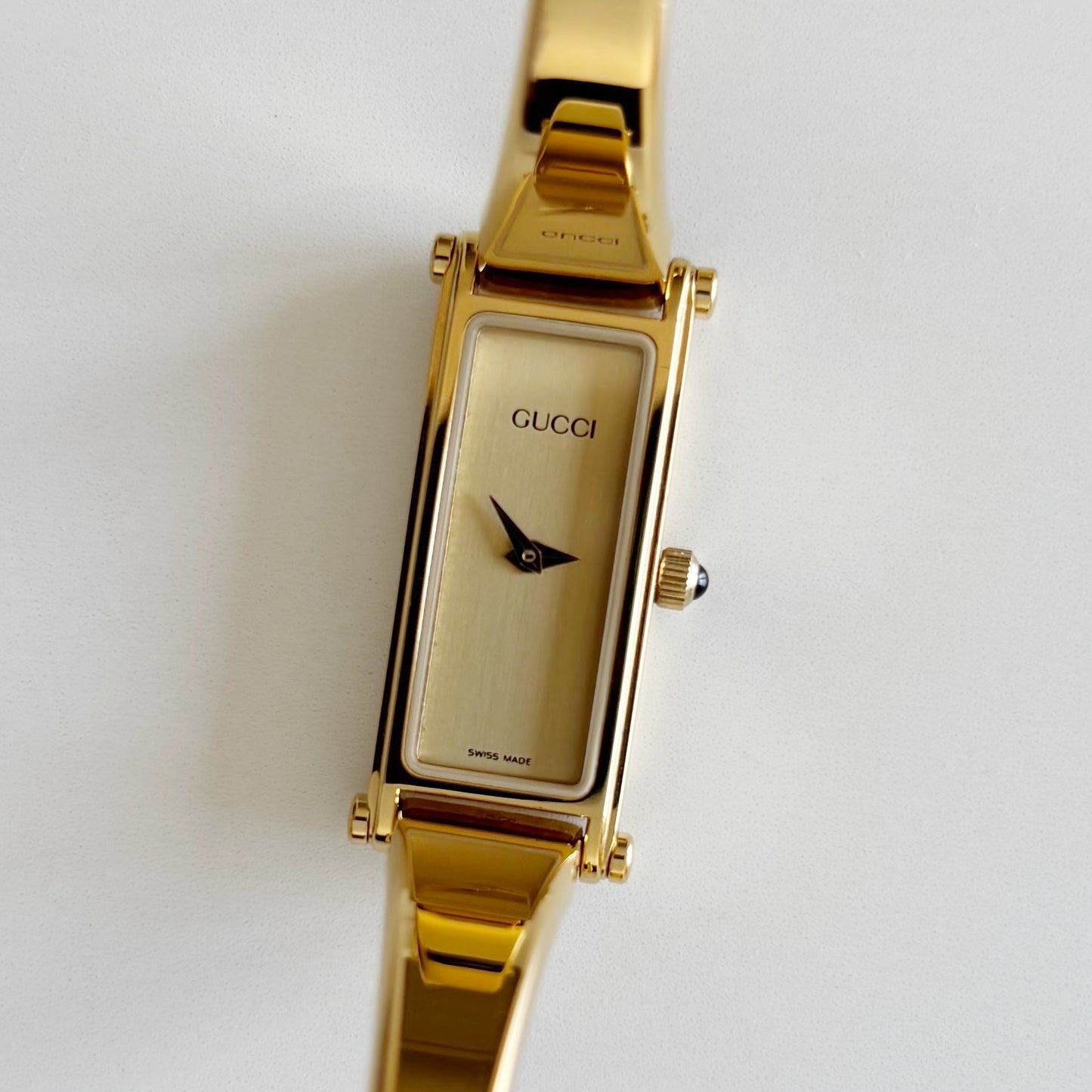 Gucci 1990s Rectangular Gold Dial Gold Plated Bangle Watch