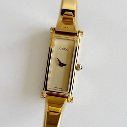 Gucci 1990s Rectangular Gold Dial Gold Plated Bangle Watch