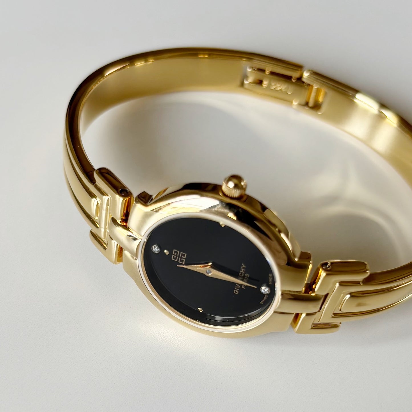 Givenchy 1990s Black Round Dial Gold Plated Bangle Watch