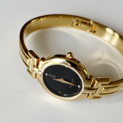 Givenchy 1990s Black Round Dial Gold Plated Bangle Watch