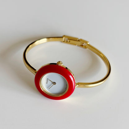 Gucci 1990s Interchangeable Bezel Gold Plated Bangle Watch with 12 bezels, case