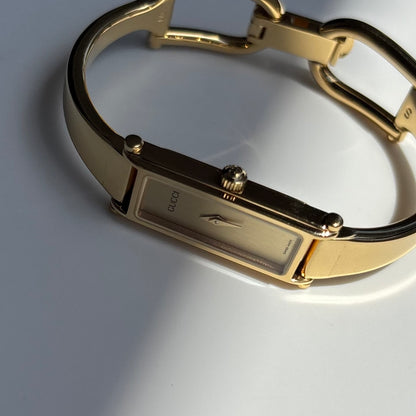 Gucci 1990s Rectangular Gold Dial Gold Plated Bangle Watch (Small)