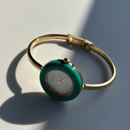 Gucci 1990s Interchangeable Bezel Gold Plated Bangle Watch with 12 bezels, case