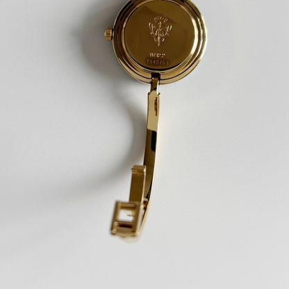 Gucci 1990s Interchangeable Bezel Gold Plated Bangle Watch with 12 bezels, case