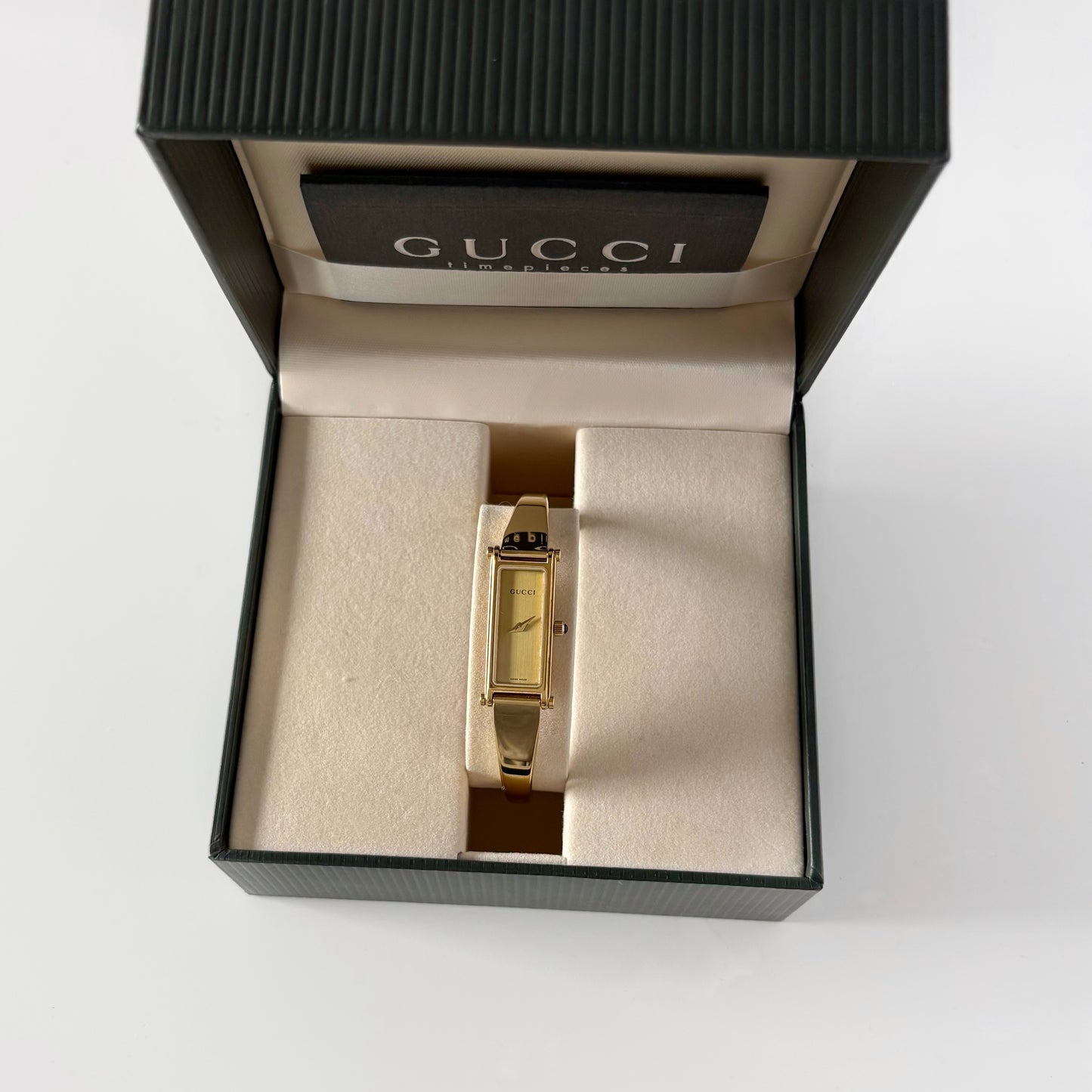 Gucci 1990s Rectangular Gold Dial Gold Plated Bangle Watch