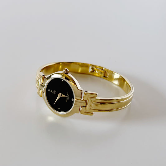 Givenchy 1990s Black Round Dial Gold Plated Bangle Watch