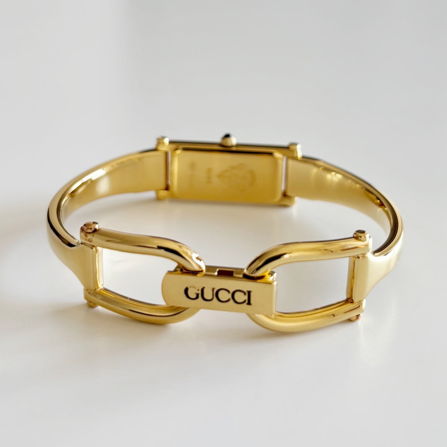 Gucci 1990s Rectangular Gold Dial Gold Plated Bangle Watch