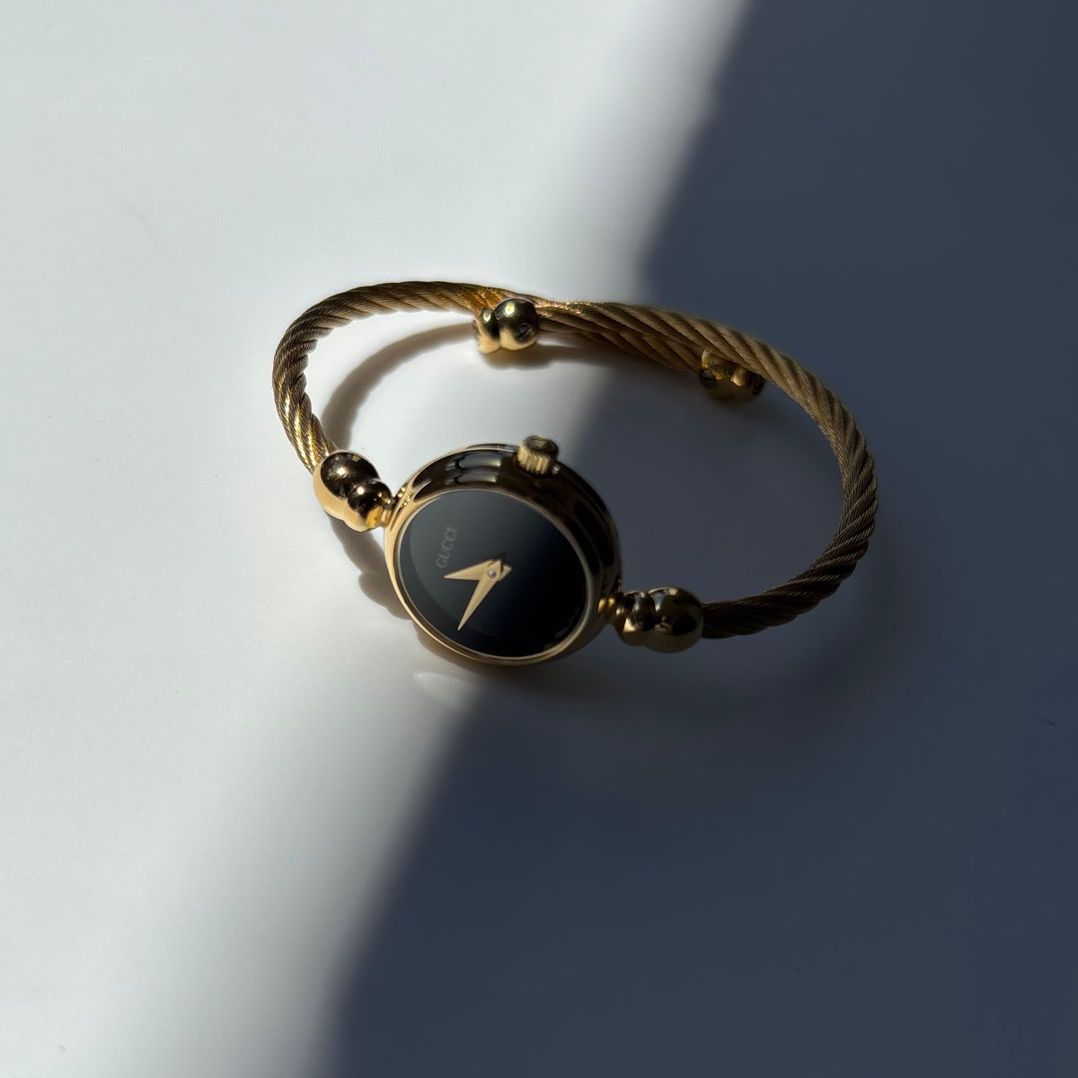 Gucci 1990s Black Round Dial Cable Gold-Plated Bangle Watch