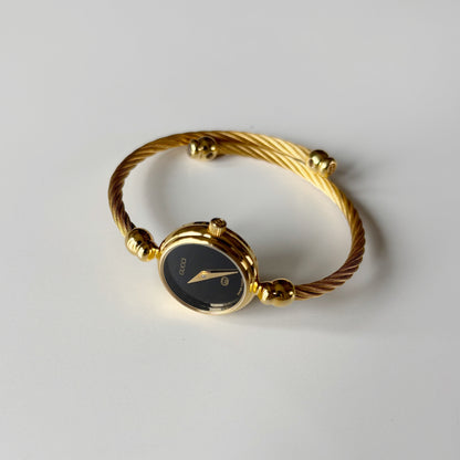 Gucci 1990s Black Round Dial Cable Gold Plated Bangle Watch