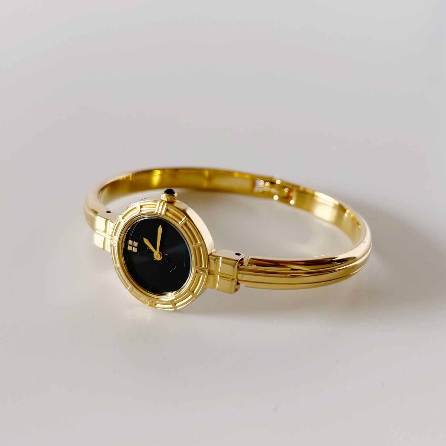 Yves Saint Laurent 1990s Black Round Dial Gold Plated Bangle Watch