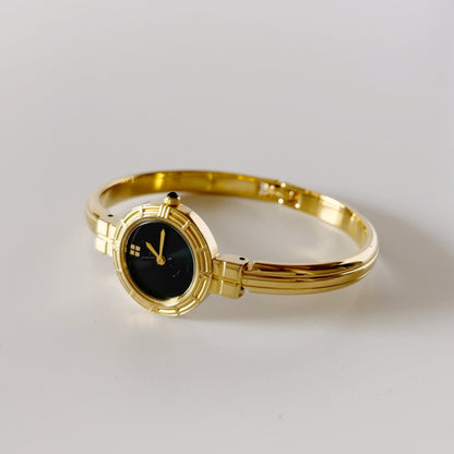 Yves Saint Laurent 1990s Black Round Dial Gold Plated Bangle Watch