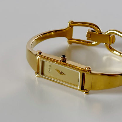 Gucci 1990s Rectangular Gold Dial Gold Plated Bangle Watch