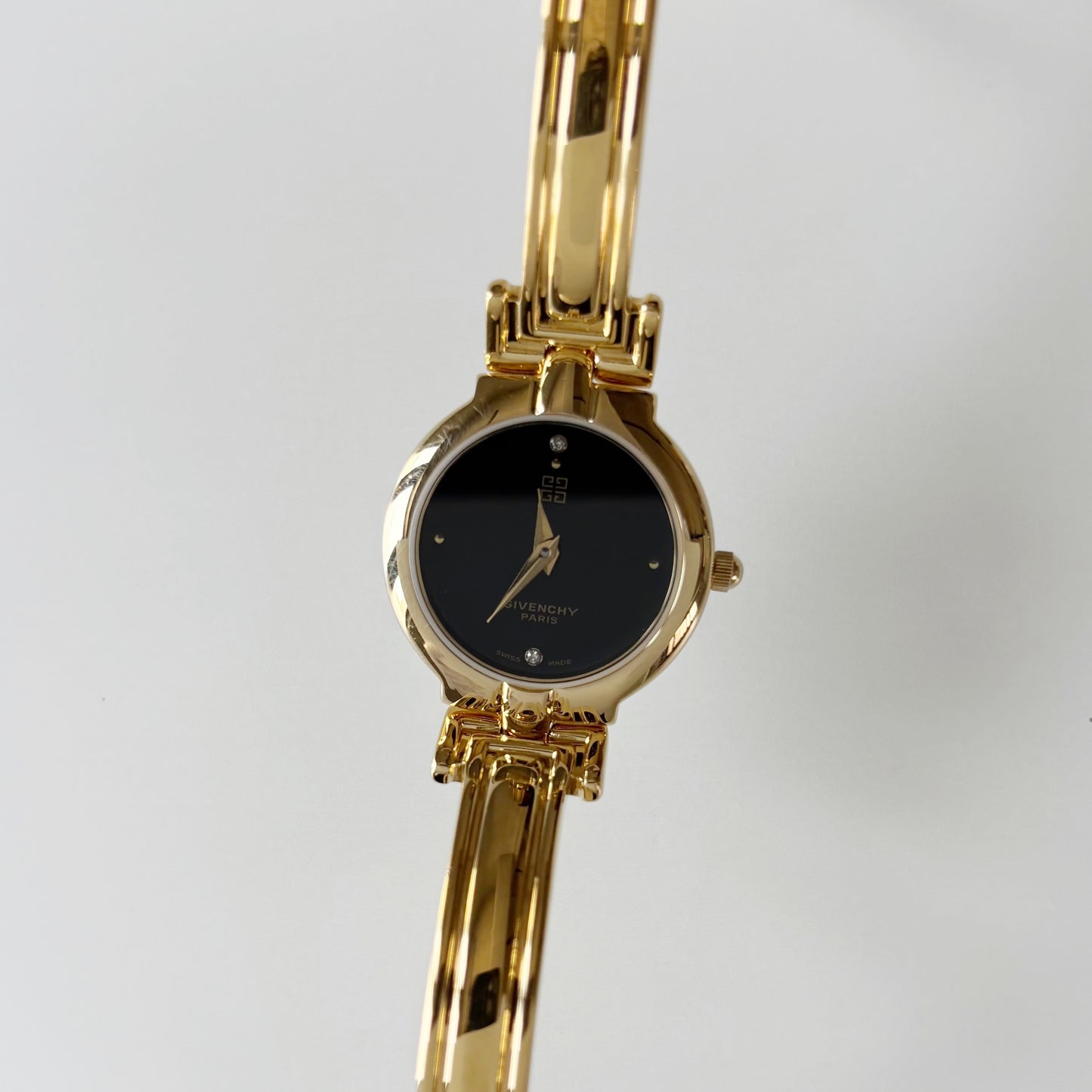 Givenchy 1990s Black Round Dial Gold Plated Bangle Watch