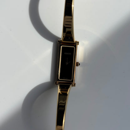 Gucci 1990s Rectangular Black Dial Gold Plated Bangle Watch