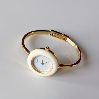 Gucci 1990s Interchangeable Bezel Gold Plated Bangle Watch with case, 12 bezels (Small)