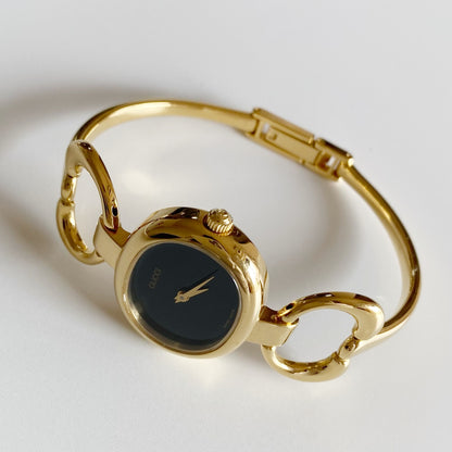 Gucci 1990s Black Dial Gold Plated Bangle Watch