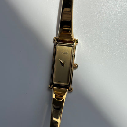 Gucci 1990s Rectangular Gold Dial Gold Plated Bangle Watch