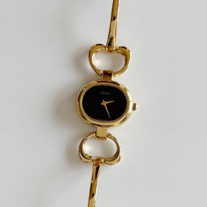 Gucci 1990s Oval Black Dial Gold Plated Bangle Watch (Small)