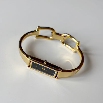 Gucci 1990s Black Rectangular Dial Gold Plated Bangle Watch