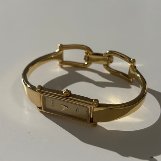Gucci 1990s Rectangular Gold Dial Gold Plated Bangle Watch
