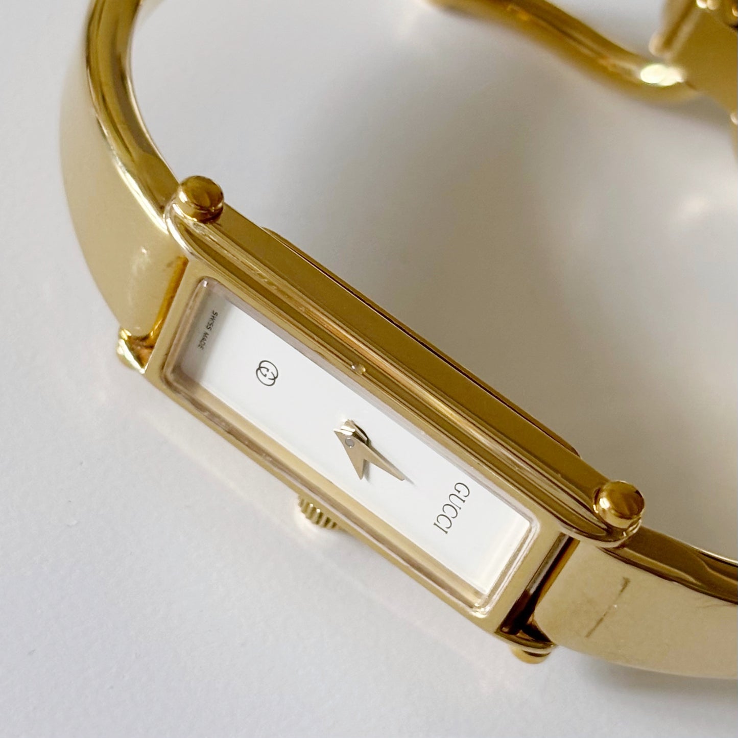 Gucci 1990s Rectangular White Dial Gold Plated Bangle Watch