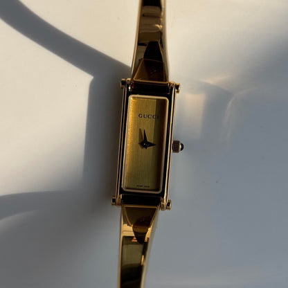 Gucci 1990s Rectangular Gold Dial Gold Plated Bangle Watch