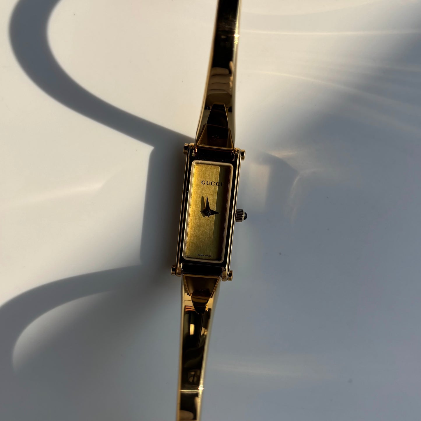 Gucci 1990s Rectangular Gold Dial Gold Plated Bangle Watch