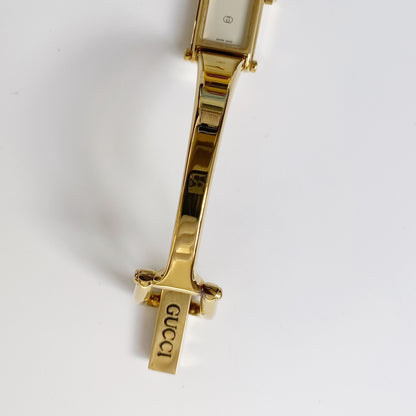 Gucci 1990s Rectangular White Dial Gold Plated Bangle Watch