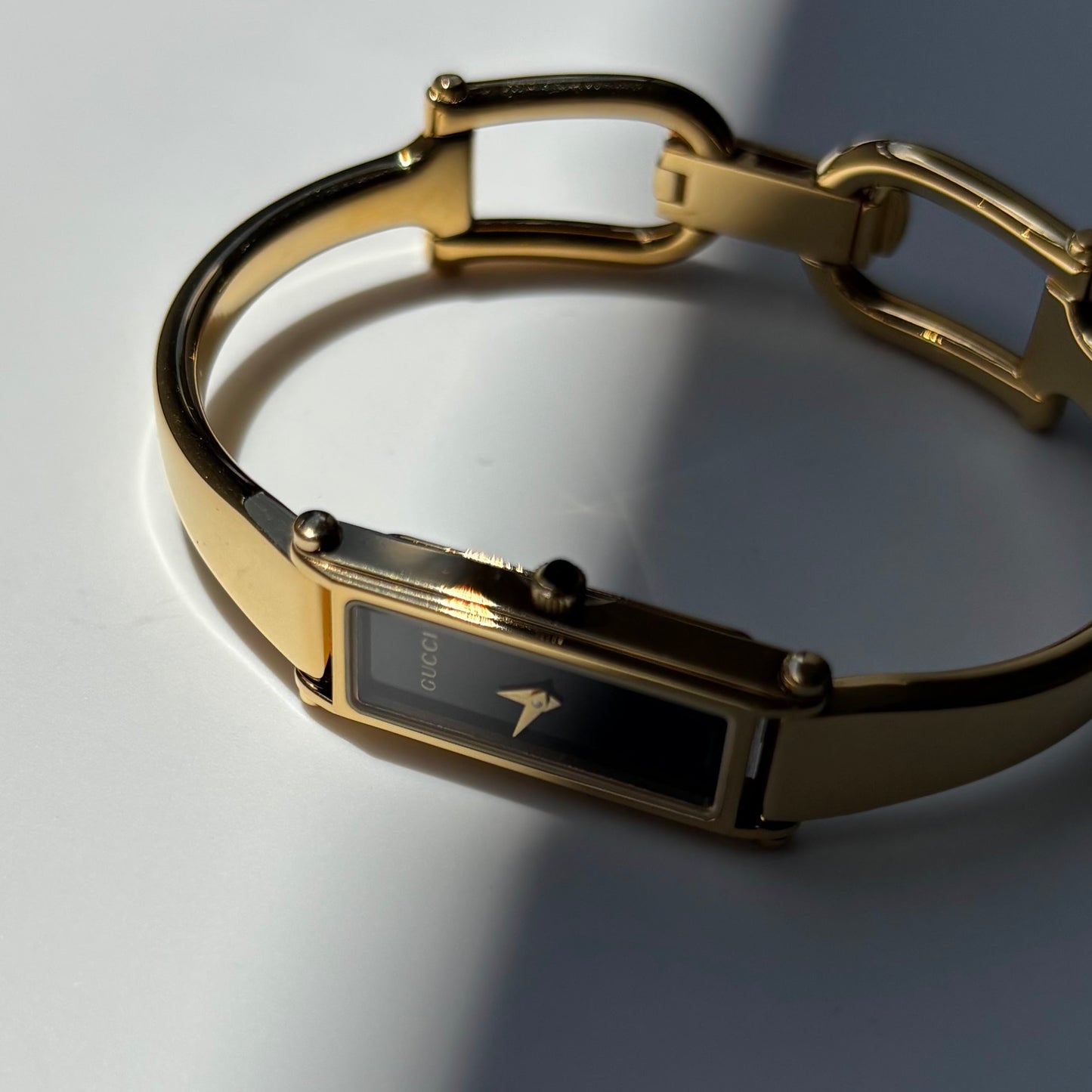 Gucci 1990s Black Rectangular Dial Gold Plated Bangle Watch