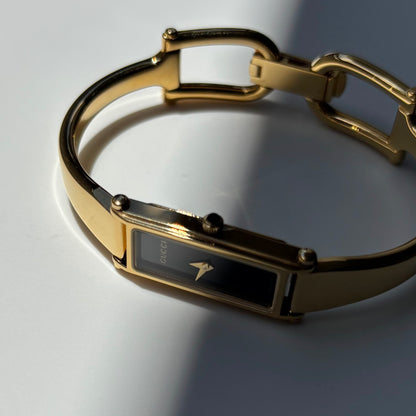 Gucci 1990s Black Rectangular Dial Gold Plated Bangle Watch