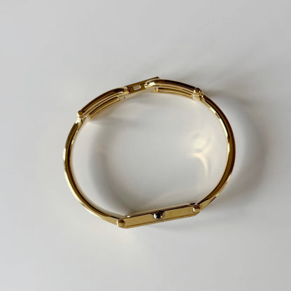 Gucci 1990s Black Rectangular Dial Gold Plated Bangle Watch