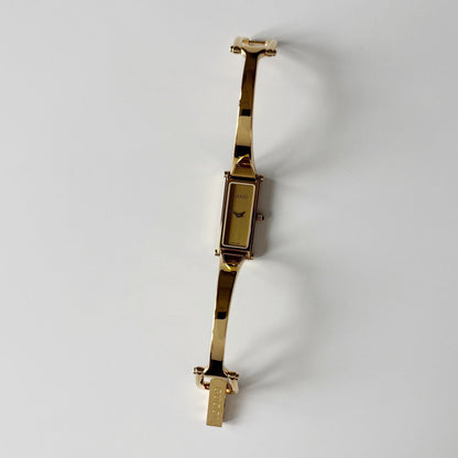 Gucci 1990s Gold Rectangular Dial Gold Plated Bangle Watch