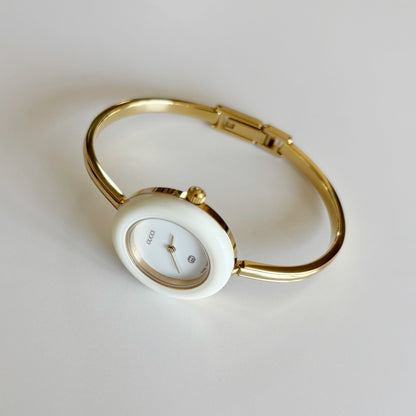 Gucci 1980s Interchangeable Bezel Gold Plated Bangle Watch with 12 bezels, case