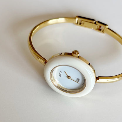 Gucci 1990s Interchangeable Bezel Gold Plated Bangle Watch with 12 bezels, case