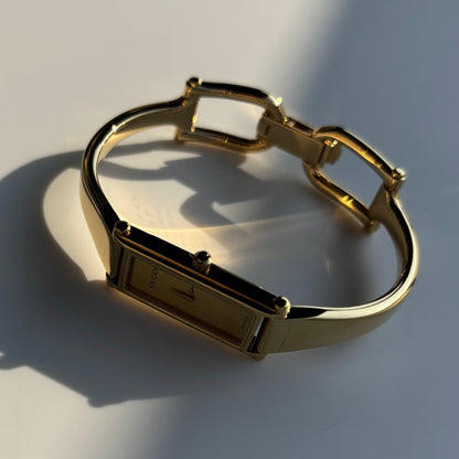 Gucci 1990s Rectangular Gold Dial Gold Plated Bangle Watch