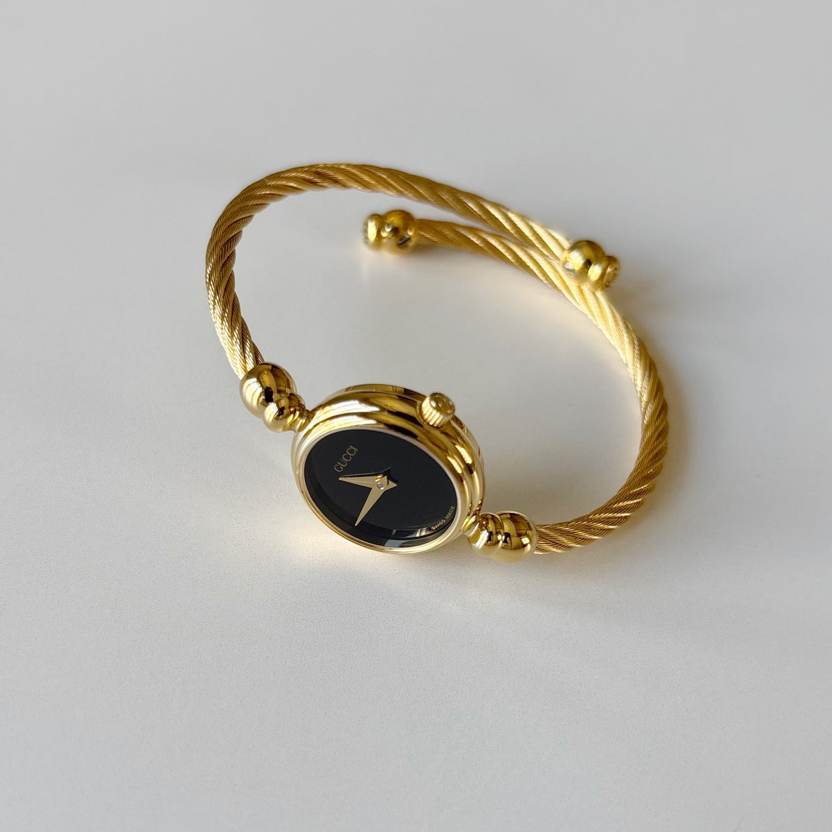Gucci 1990s Black Round Dial Cable Gold-Plated Bangle Watch