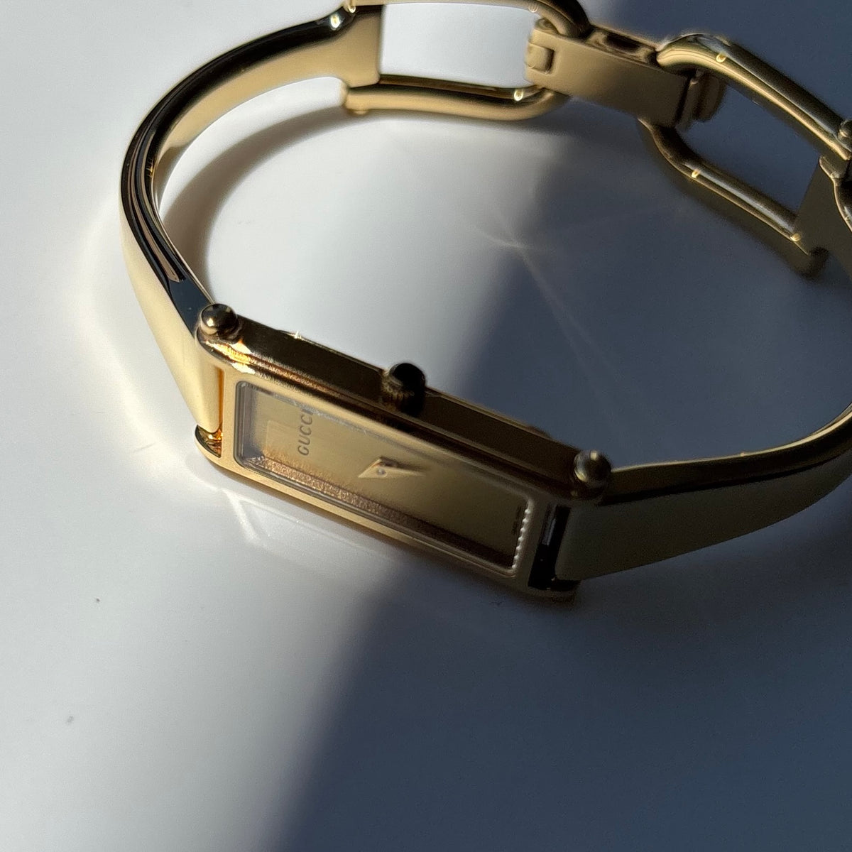 Gucci 1990s Rectangular Gold Dial Gold-Plated Watch