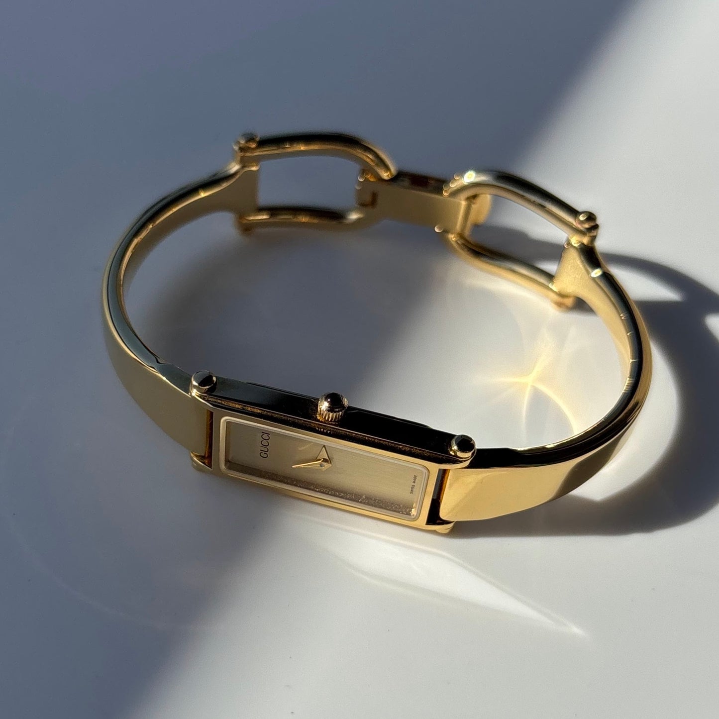 Gucci 1990s Rectangular Gold Dial Gold Plated Bangle Watch