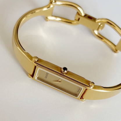 Gucci 1990s Rectangular Gold Dial Gold Plated Bangle Watch