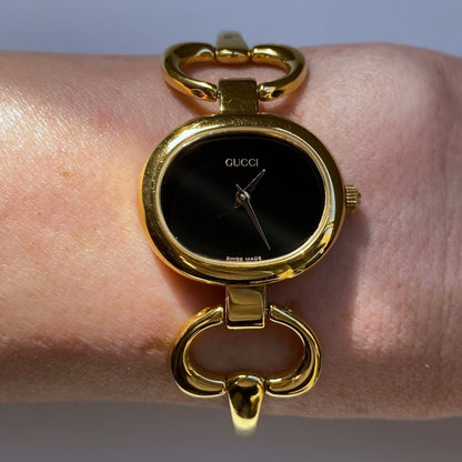 Gucci 1990s Black Dial Oval Gold Plated Bangle Watch