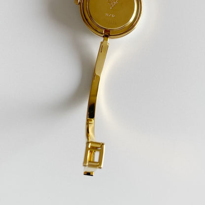 Gucci 1990s Interchangeable Bezel Gold Plated Bangle Watch with 12 bezels, case