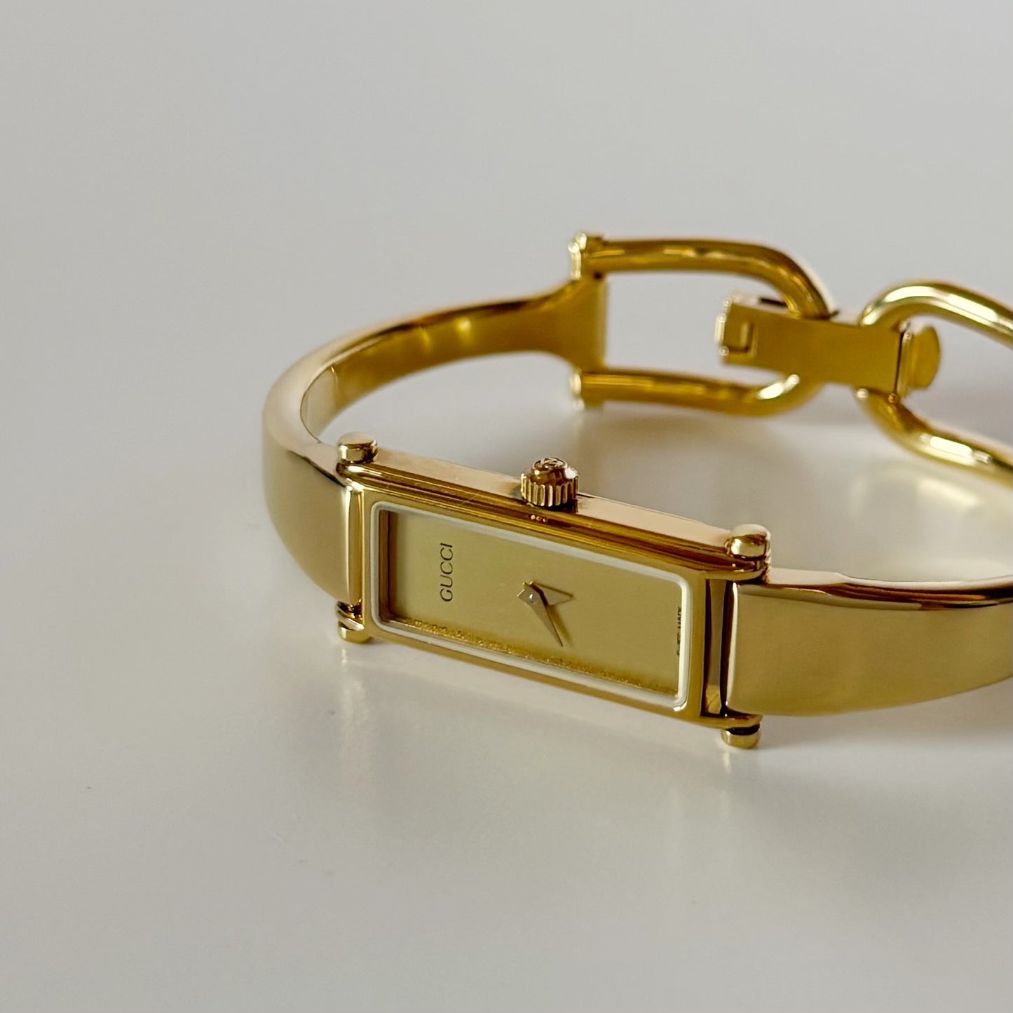 Gucci 1990s Gold Rectangular Dial Gold Plated Bangle Watch