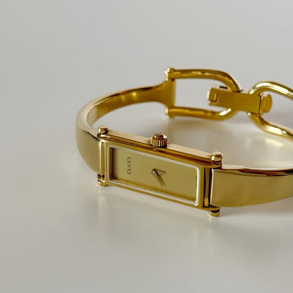 Gucci 1990s Gold Rectangular Dial Gold Plated Bangle Watch