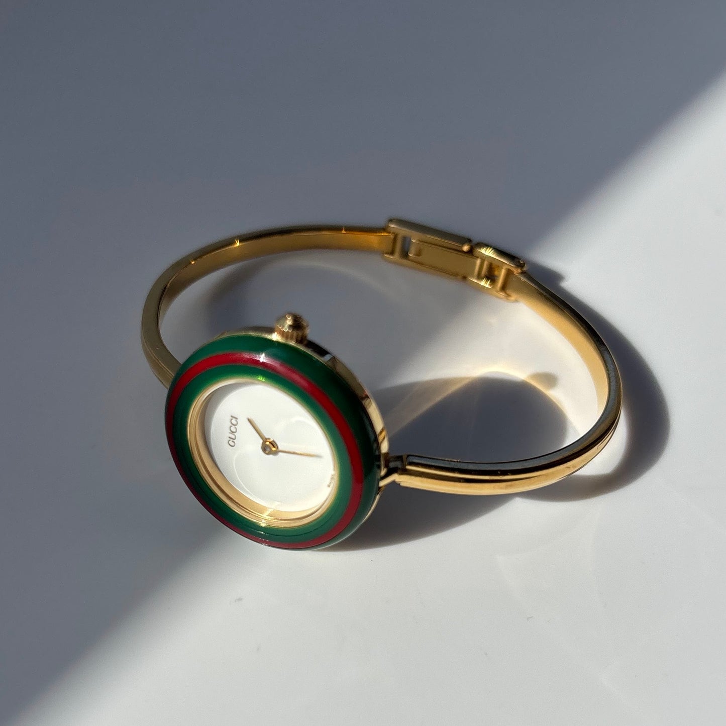 Gucci 1990s Interchangeable Bezel Gold Plated Bangle Watch with 12 bezels, case