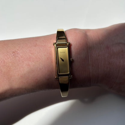 Gucci 1990s Rectangular Gold Dial Gold Plated Bangle Watch